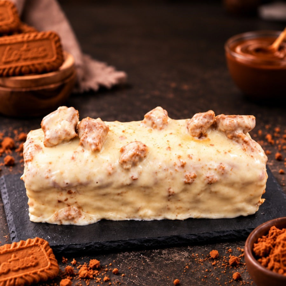 Rhukra Cake House Korean Caramel Crunch cake with creamy frosting and biscuit toppings on a slate board