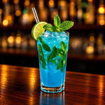 Rhukra Cake House Blue Curacao Mojito Cooler with fresh mint, lime slice, and ice in a glass on a wooden bar counter.