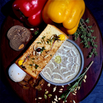 Rhukra Cake House Mushroom Cappuccino soup served with toasted biscotti, truffle oil, and fresh herbs on a wooden board