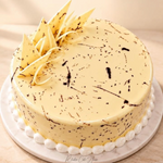 Rhukra Cake House Vancho signature dessert featuring a smooth vanilla glaze with chocolate drizzle and white shards.